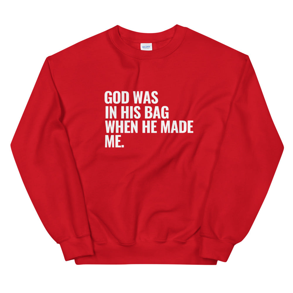 Red crewneck sweatshirt with writing. God was in his bag when he made me.